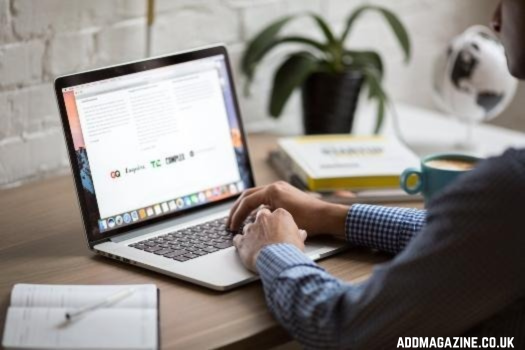 a man looking at a website on his laptop